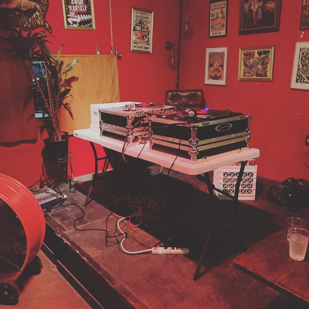 two turntables set up indoors at colorful bar